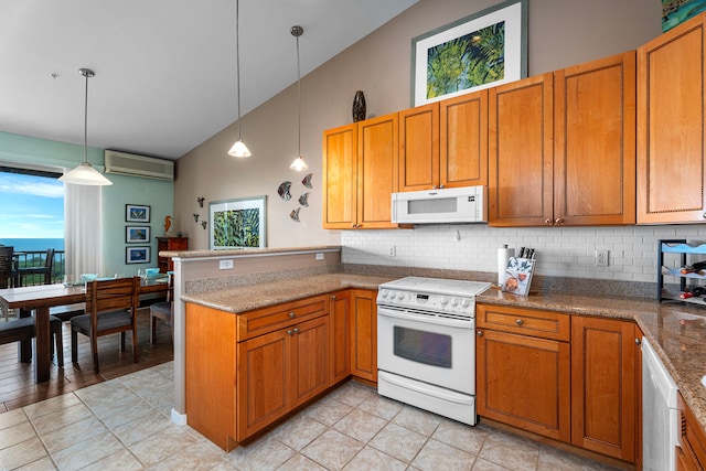 75-346 Hualalai Rd Unit B303, Kailua-Kona, HI 96740 - kitchen with white appliances, an AC wall unit, a peninsula, decorative backsplash, and high vaulted ceiling