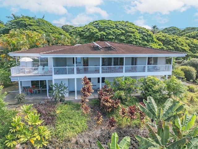 75-795 Hiona St, Kailua-Kona, HI 96740 - rear view of house featuring a patio area, stucco siding, and a wooded view