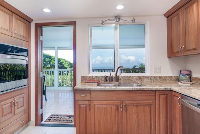 75-795 Hiona St, Kailua-Kona, HI 96740 - kitchen featuring appliances with stainless steel finishes, brown cabinetry, light tile patterned flooring, and recessed lighting