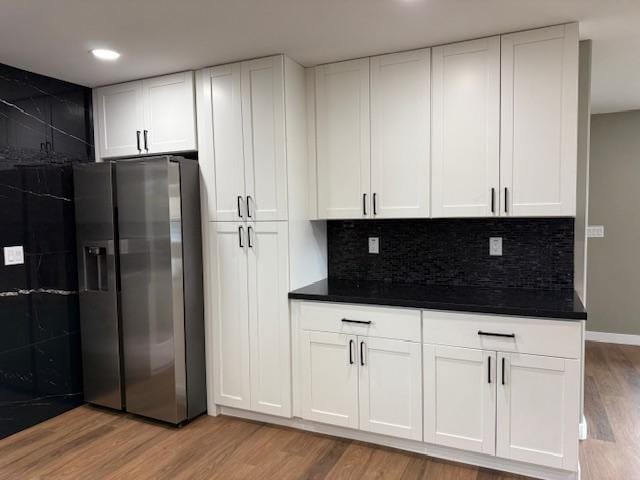 144 Chong St, Hilo, HI 96720 - kitchen featuring stainless steel refrigerator with ice dispenser, dark countertops, light wood-type flooring, and recessed lighting