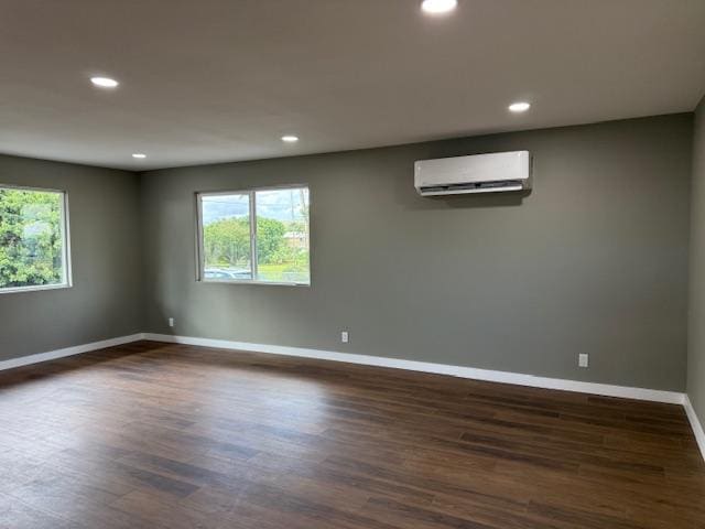 144 Chong St, Hilo, HI 96720 - unfurnished room with an AC wall unit, recessed lighting, and dark wood-type flooring
