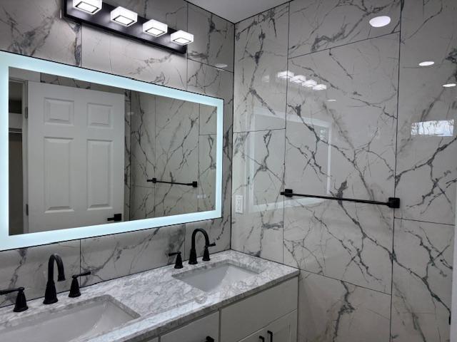 144 Chong St, Hilo, HI 96720 - bathroom featuring double vanity and tile walls