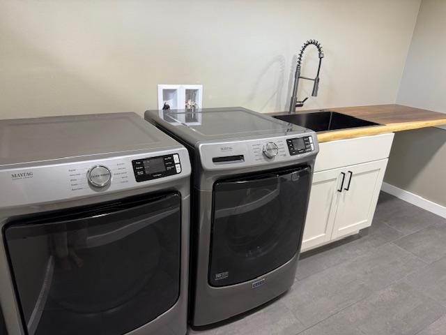 144 Chong St, Hilo, HI 96720 - laundry area with washing machine and dryer, cabinet space, and tile patterned flooring