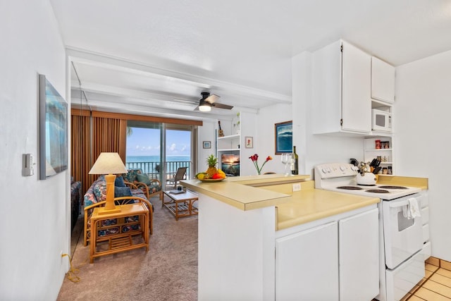 75-5870 Kahakai Rd Unit 308, Kailua-Kona, HI 96740 - kitchen featuring white appliances, light countertops, white cabinetry, and light carpet