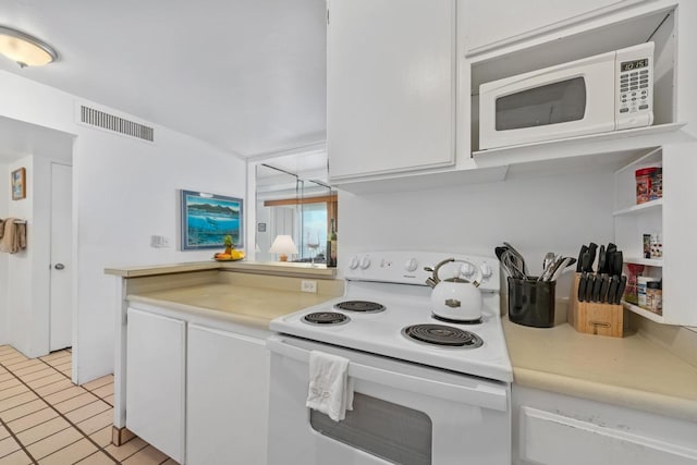 75-5870 Kahakai Rd Unit 308, Kailua-Kona, HI 96740 - kitchen featuring white appliances, white cabinets, light countertops, and light tile patterned floors