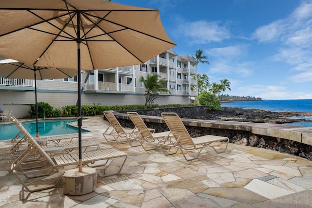 75-5870 Kahakai Rd Unit 308, Kailua-Kona, HI 96740 - view of patio featuring a water view and an outdoor pool