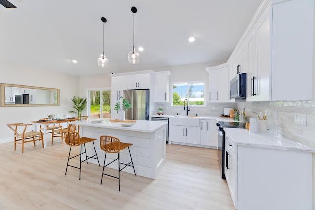 15-1955 Beach Rd, Keaau, HI 96749 - kitchen featuring stainless steel appliances, a kitchen breakfast bar, backsplash, plenty of natural light, and recessed lighting