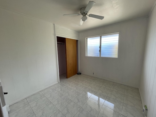 4548 Kawailoa St, Kekaha, HI 96752 - unfurnished bedroom featuring a closet, light marble finish floors, and a ceiling fan