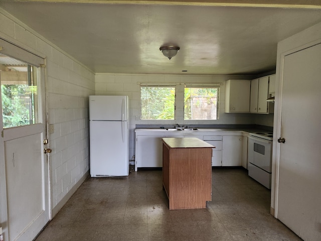 15-1724 22nd Ave, Keaau, HI 96749 - kitchen featuring white appliances, a center island, butcher block counters, dark flooring, and white cabinets
