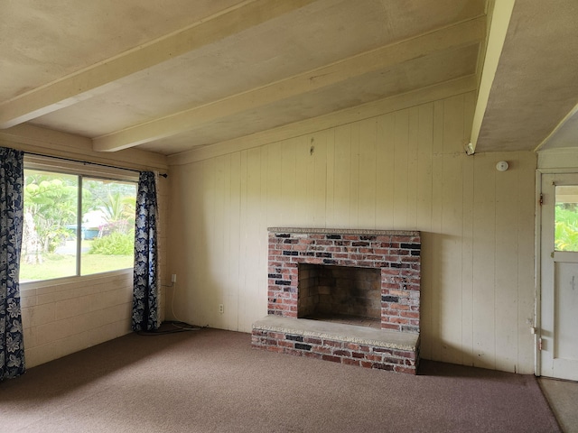 15-1724 22nd Ave, Keaau, HI 96749 - unfurnished living room with beam ceiling, carpet, wooden walls, and a brick fireplace