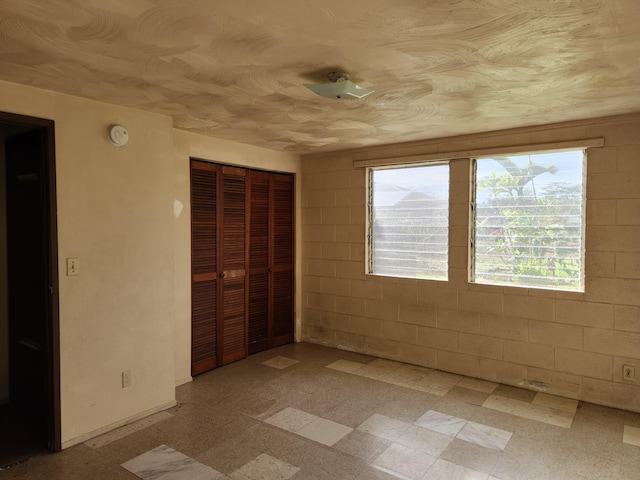 15-1724 22nd Ave, Keaau, HI 96749 - unfurnished bedroom with multiple windows, a closet, and light floors