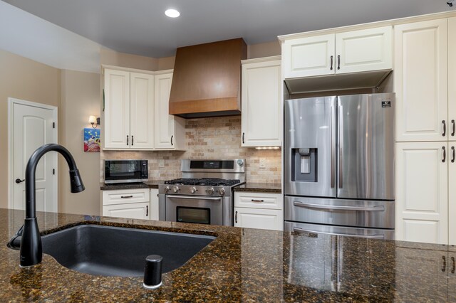 71-1861 Puu Lani Loop, Kailua-Kona, HI 96740 - kitchen with stainless steel appliances, premium range hood, decorative backsplash, dark stone countertops, and white cabinetry