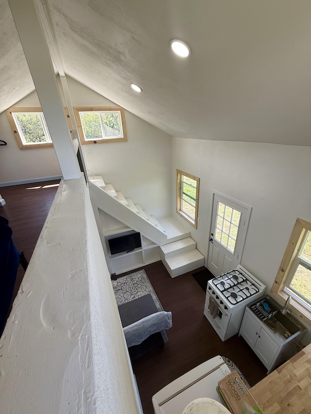 94 Pele St, Naalehu, HI 96772 - stairs with lofted ceiling, wood finished floors, and recessed lighting