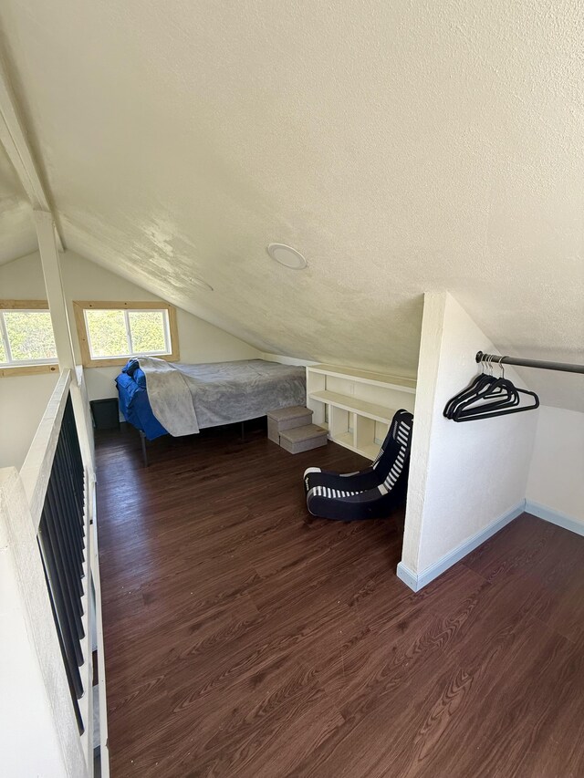 94 Pele St, Naalehu, HI 96772 - unfurnished bedroom with wood finished floors, vaulted ceiling, and a textured ceiling