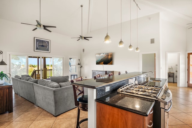3238 Unahe St, Lihue, HI 96766 - kitchen featuring high vaulted ceiling, open floor plan, stainless steel gas range oven, a kitchen breakfast bar, and ceiling fan