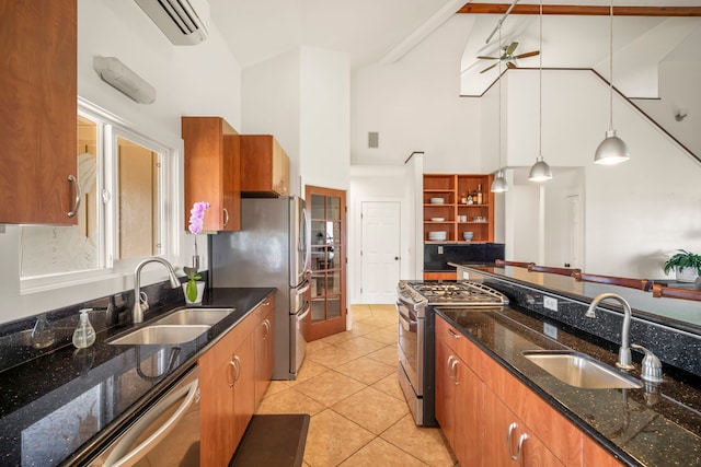 3238 Unahe St, Lihue, HI 96766 - kitchen with stainless steel appliances, high vaulted ceiling, brown cabinetry, a ceiling fan, and pendant lighting