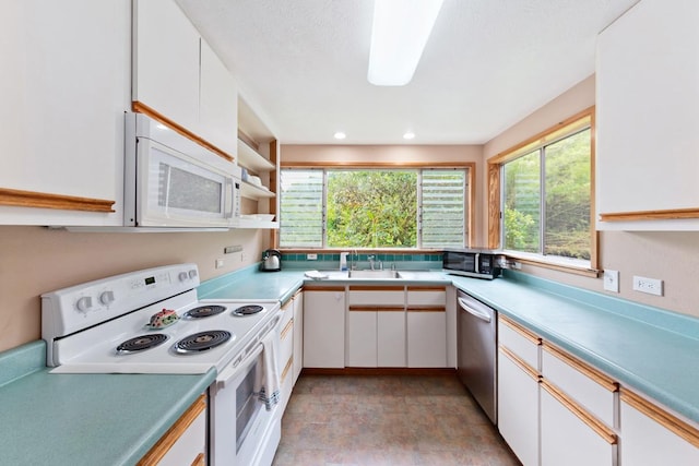 1436 Maikalani St, Hilo, HI 96720 - kitchen with stainless steel appliances, light countertops, white cabinets, and stone finish flooring