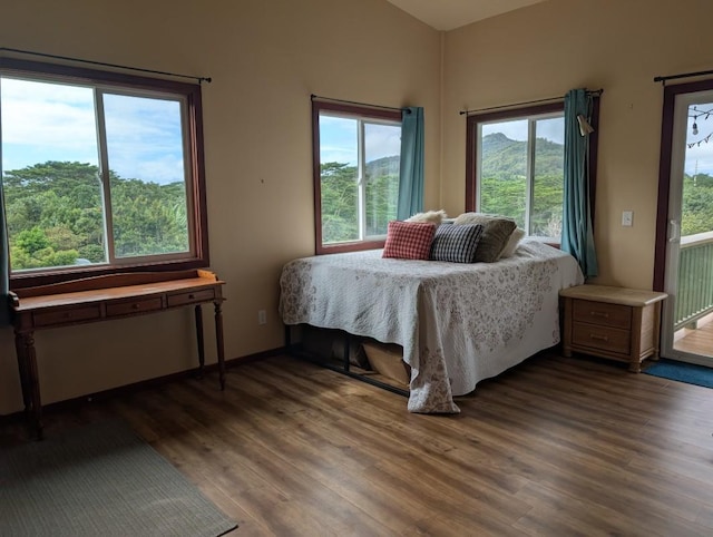 5565-D Hauiki Rd, Kapaa, HI 96746 - bedroom with wood finished floors, multiple windows, and access to exterior