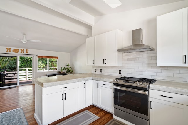 6100 Kawaihau Rd, Kapaa, HI 96746 - kitchen with stainless steel gas range oven, wall chimney range hood, a peninsula, light countertops, and tasteful backsplash