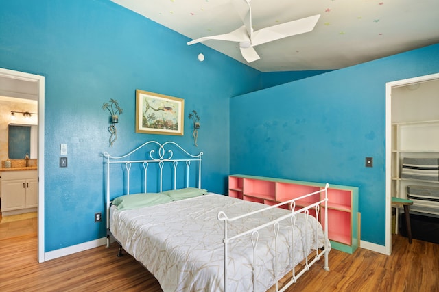 6100 Kawaihau Rd, Kapaa, HI 96746 - bedroom featuring wood finished floors, lofted ceiling, a skylight, ceiling fan, and a walk in closet