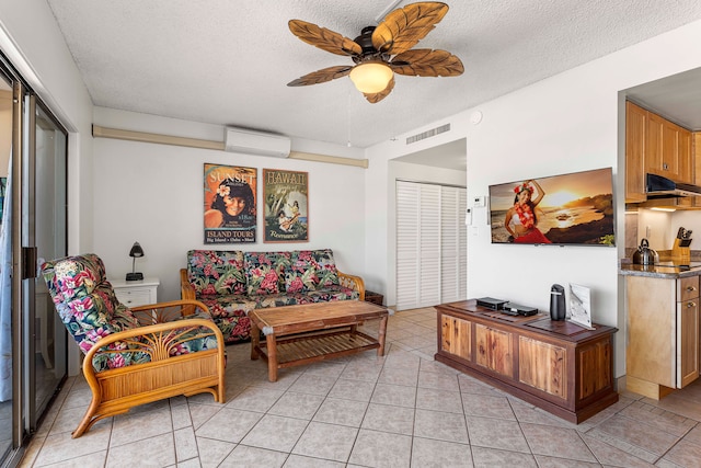 75-5719 Kona Plz Unit 203, Kailua-Kona, HI 96740 - living area with a wall unit AC, a textured ceiling, ceiling fan, and light tile patterned flooring