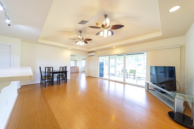321 Noelani Loop, Hilo, HI 96720 - living room featuring a raised ceiling, a ceiling fan, a wall unit AC, light wood finished floors, and recessed lighting