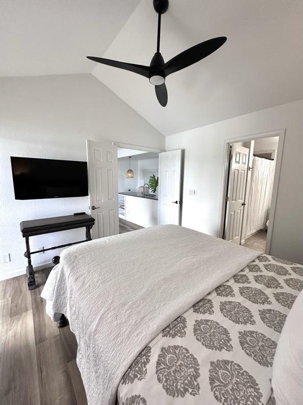 68-3883 Lua Kula St Unit 707, Waikoloa, HI 96738 - bedroom featuring vaulted ceiling, wood finished floors, and ceiling fan
