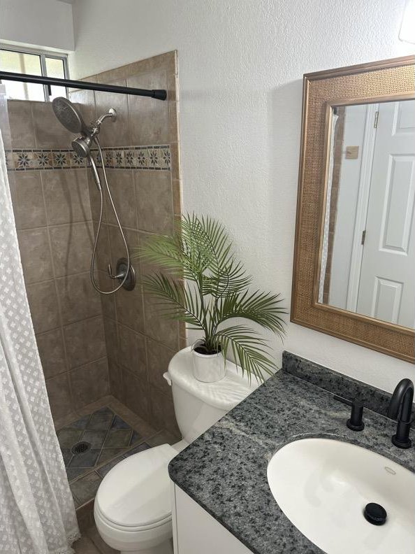 68-3883 Lua Kula St Unit 707, Waikoloa, HI 96738 - bathroom featuring vanity, a shower stall, and a textured wall
