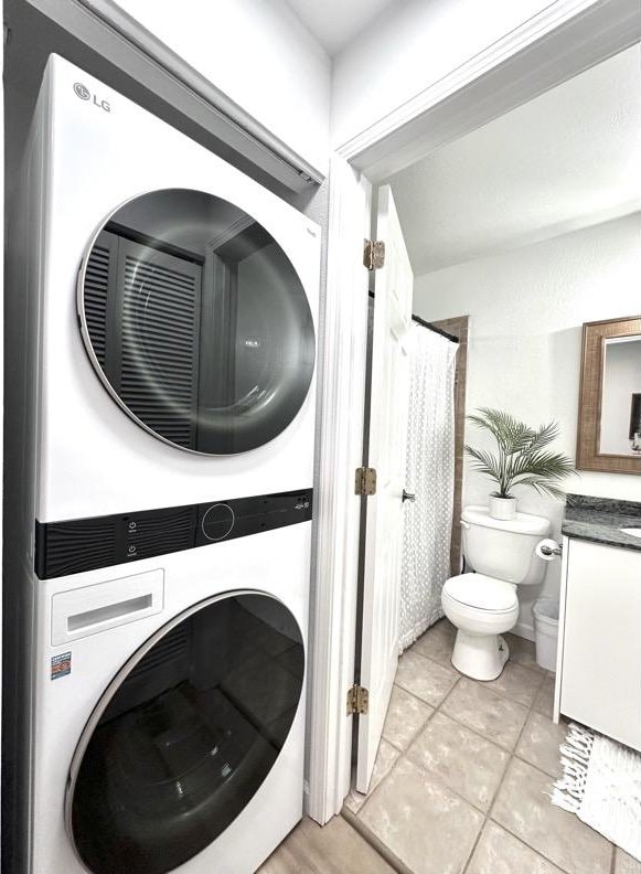 68-3883 Lua Kula St Unit 707, Waikoloa, HI 96738 - laundry area with stacked washing machine and dryer and light tile patterned floors