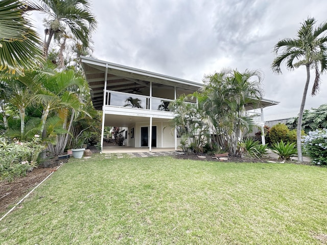 73-1259 Melomelo St, Kailua-Kona, HI 96740 - back of house with a sunroom, a patio, and a yard