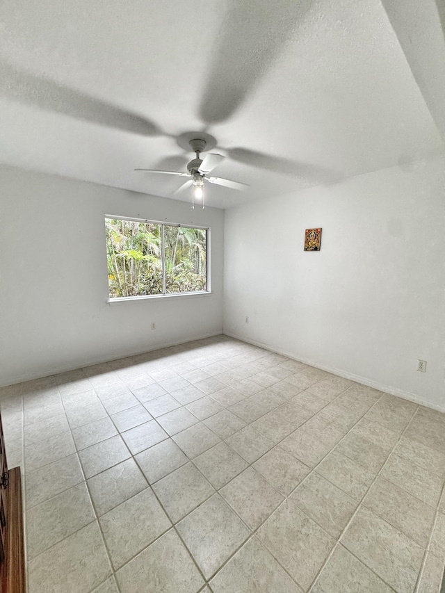 73-1259 Melomelo St, Kailua-Kona, HI 96740 - empty room with light tile patterned floors, ceiling fan, and a textured ceiling