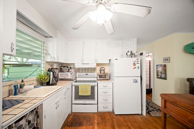 147 Royal Dr, Kapaa, HI 96746 - kitchen with white appliances, tile countertops, dark wood-type flooring, under cabinet range hood, and white cabinets