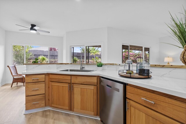 68-1685 Alana St, Waikoloa, HI 96738 - kitchen featuring stainless steel dishwasher, light wood finished floors, light stone countertops, a ceiling fan, and brown cabinetry