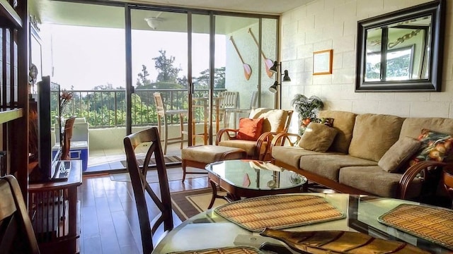 1875 Kalanianaole St Unit 504, Hilo, HI 96720 - living area with plenty of natural light, concrete block wall, and wood finished floors
