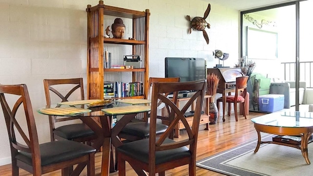 1875 Kalanianaole St Unit 504, Hilo, HI 96720 - dining space featuring wood finished floors and concrete block wall
