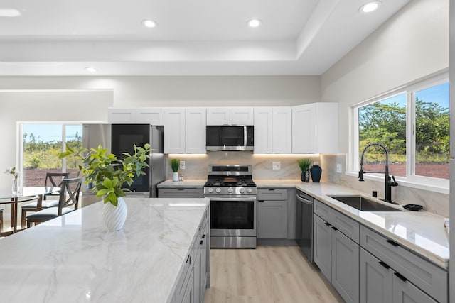 15-1628 Loke Rd, Keaau, HI 96749 - kitchen with appliances with stainless steel finishes, gray cabinetry, backsplash, recessed lighting, and light stone countertops