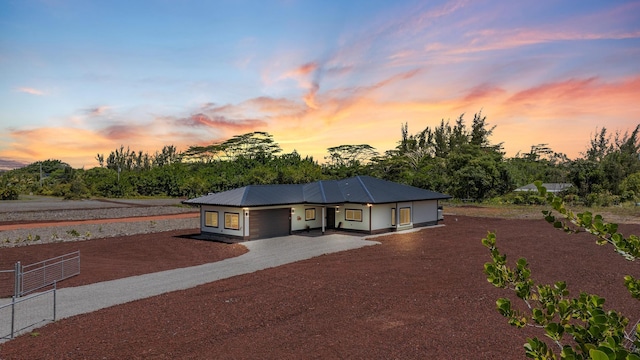 15-1628 Loke Rd, Keaau, HI 96749 - view of front facade with driveway, a garage, and a metal roof