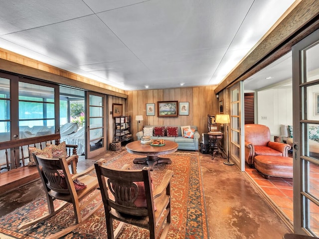 86-4190 Hookena Beach Rd, Captain Cook, HI 96704 - living room featuring finished concrete flooring, wooden walls, and french doors