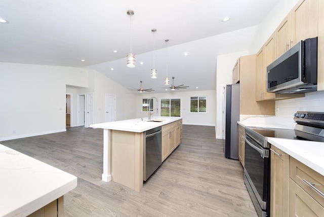 2672 Kuku St, Hilo, HI 96720 - kitchen featuring appliances with stainless steel finishes, open floor plan, light brown cabinets, lofted ceiling, and light wood-style flooring