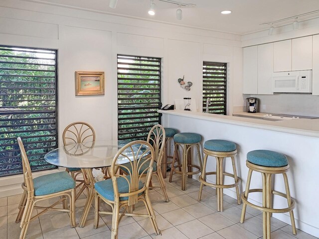 2253 Poipu Rd Unit 28, Koloa, HI 96756 - dining area featuring light tile patterned flooring, track lighting, and wine cooler