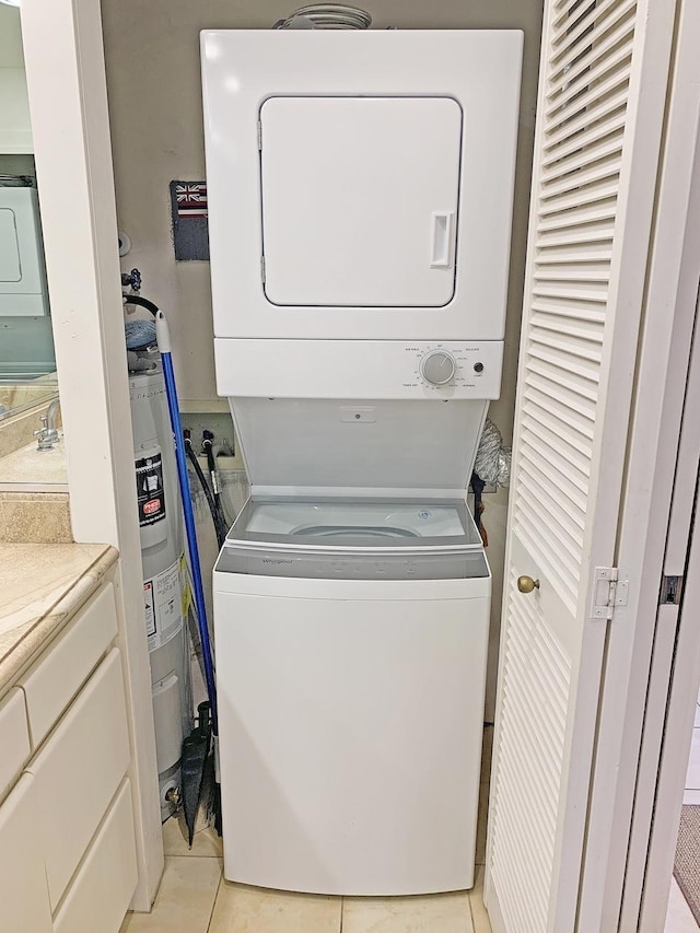 2253 Poipu Rd Unit 28, Koloa, HI 96756 - laundry room with stacked washer / drying machine, light tile patterned floors, and water heater