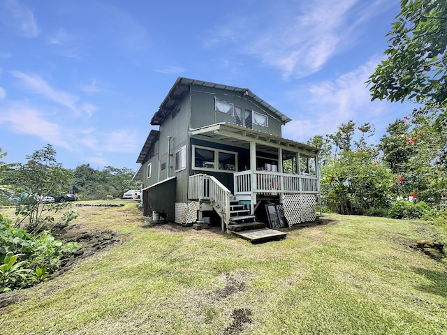 15-1414 18th Ave, Keaau, HI 96749 - back of property featuring a lawn, stairs, and a deck