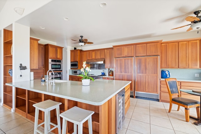1690 Keleka Rd, Koloa, HI 96756 - kitchen featuring ceiling fan, appliances with stainless steel finishes, beverage cooler, and light tile patterned floors