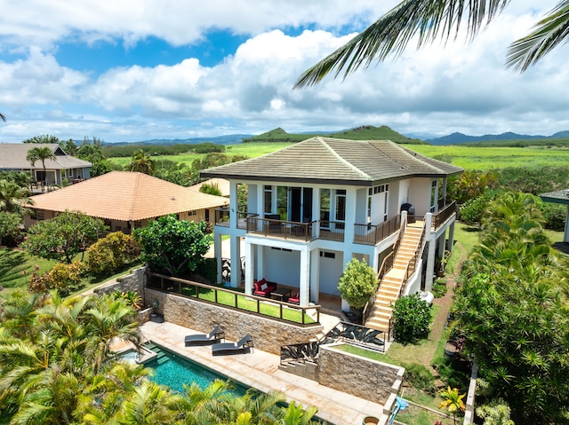 1690 Keleka Rd, Koloa, HI 96756 - rear view of house featuring stucco siding, stairs, a patio area, and a pool with connected hot tub