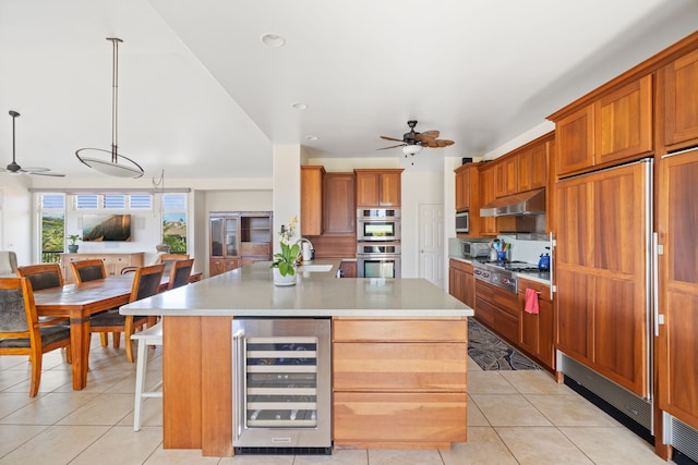 1690 Keleka Rd, Koloa, HI 96756 - kitchen with beverage cooler, a ceiling fan, appliances with stainless steel finishes, and brown cabinets
