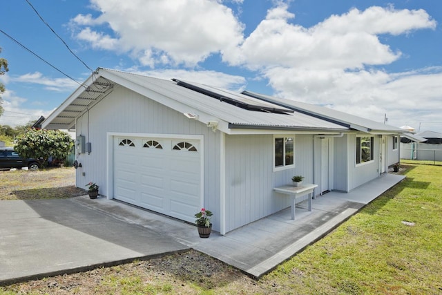 25-228 Hana St, Hilo, HI 96720 - view of property exterior featuring a garage, solar panels, a metal roof, and driveway