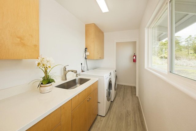 25-228 Hana St, Hilo, HI 96720 - laundry area featuring washing machine and clothes dryer, cabinet space, and light wood-type flooring