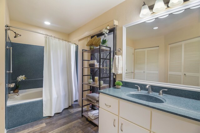 3920 Wyllie Rd Unit 6A, Princeville, HI 96722 - bathroom with wood finished floors, a closet, vanity, shower / bath combo with shower curtain, and recessed lighting
