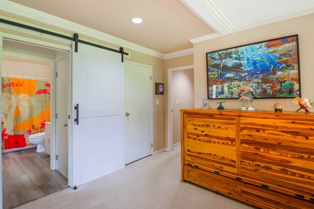 3920 Wyllie Rd Unit 6A, Princeville, HI 96722 - bedroom featuring a barn door, ornamental molding, recessed lighting, light colored carpet, and ensuite bath