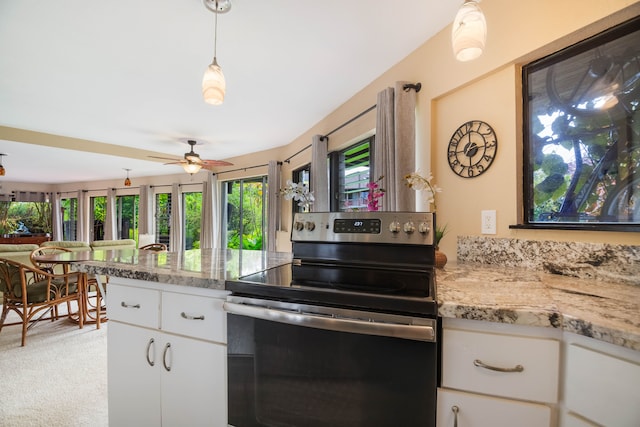3920 Wyllie Rd Unit 6A, Princeville, HI 96722 - kitchen with electric stove, a ceiling fan, light colored carpet, white cabinetry, and decorative light fixtures